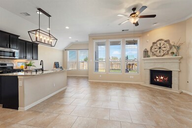 The kitchen is open to the family room where the fireplace is an elegant and warm focal point.