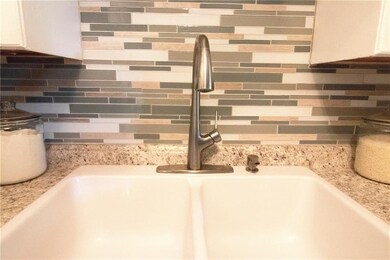 Kitchen boasts new sink and faucet, counters, glas