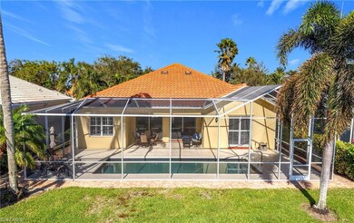 Rear view of property featuring glass enclosure, a