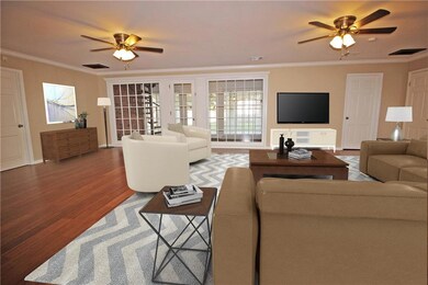 Incredible den with wood floors and windows overlo