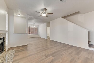 Living room with ceiling fan with notable chandeli