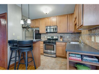 Updated kitchen featuring neutral tile flooring an