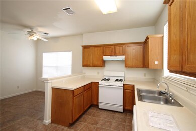 Kitchen with white gas range, a sink, under cabin