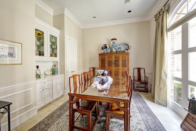 Formal dining room with floor-to-ceiling arched wi