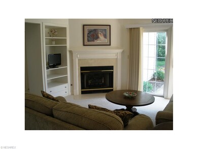 Living room features corner gas fireplace with mar