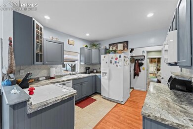 Kitchen featuring gray cabinetry, white appliances, glass insert cabinets, tasteful backsplash, and recessed lighting