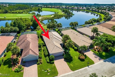 Aerial view of residential area featuring a large body of water and a local golf course