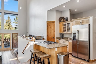 Kitchen featuring a center island, a high ceiling,