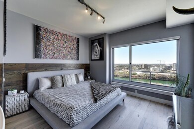Bedroom featuring track lighting, wood finished f