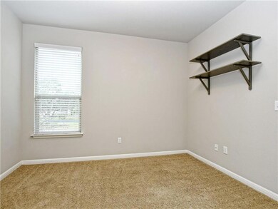 Carpeted empty room featuring baseboards