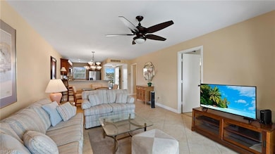 Living room featuring ceiling fan with notable cha