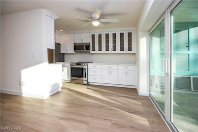 Kitchen featuring light wood-style flooring, white