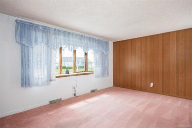 Large living room with hard wood floors underneath.