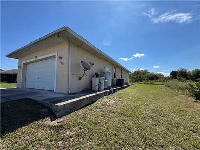 View of side of home with driveway, a garage, cent