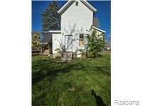 View of side of home featuring a lawn