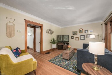 Living room as seen from he from door. Refinished hardwood floors, and natural woodwork.