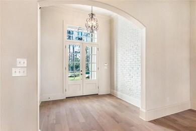 Welcome! Step inside to 12 ft. ceiling, brick acce