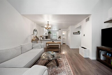 Living area with wood finished floors and a chand