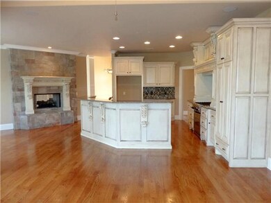 This fabulous Kitchen has gorgeous cabinetry, hardwood floors, and granite counter tops.