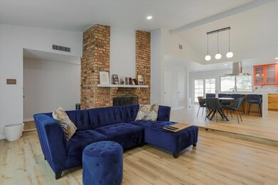 Living room with light hardwood / wood-style floor