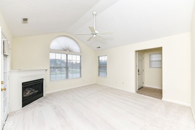 The living room has plenty of space, yet cozy with the fireplace