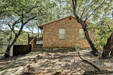 View of home's exterior with brick siding and a d