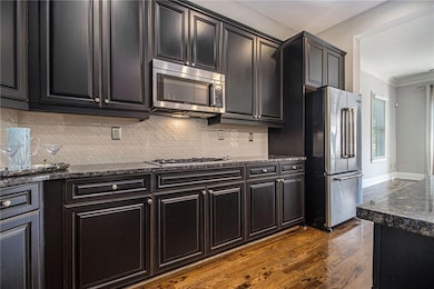Chef's kitchen with view of great room and deck.