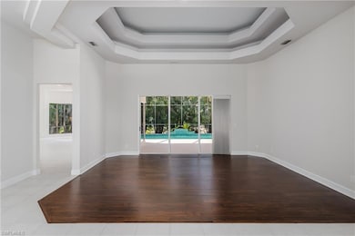 Empty room with a raised ceiling, a towering ceili