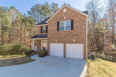 Front of property with a front lawn, a garage, and