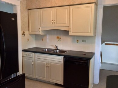 The kitchen has a breakfast bar, double stainless 