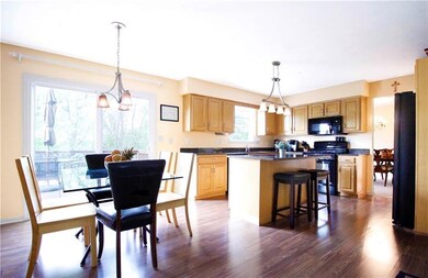 Kitchen features maple cabinets, granite, newer appliances & slider to large deck over looking wooded lot