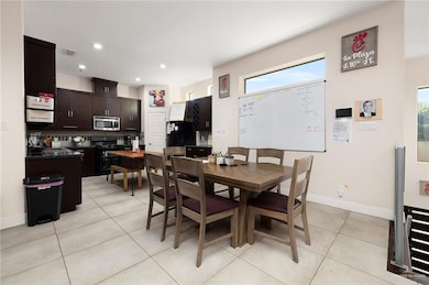 Dining room featuring plenty of natural light and light tile patterned flooring