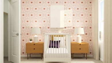 Bedroom with baseboards and a nursery area