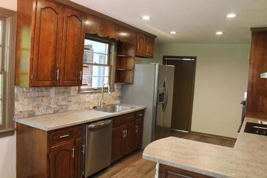 Kitchen has recessed lighting, new dishwasher, abundant cabinets, new flooring, double oven and more