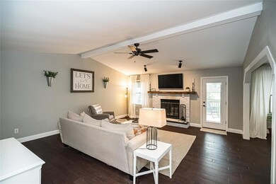 Spacious living area with vaulted ceilings and woo