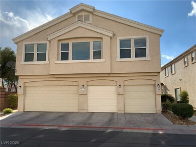 View of front facade with stucco siding and a gara
