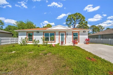 Single story home with stucco siding, fence, and a