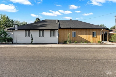 View of front of house with a shingled roof