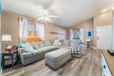 Living area with baseboards, light wood-style floo