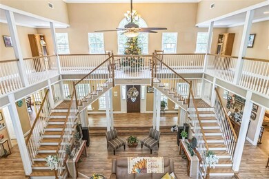 Staircase featuring wood finished floors, a toweri