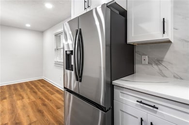 Kitchen featuring light stone countertops, wood fi