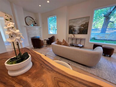 Living area featuring a brick fireplace, recessed