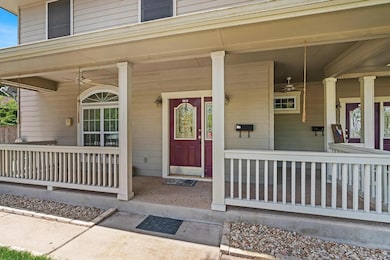 Doorway to property featuring ceiling fan and cov