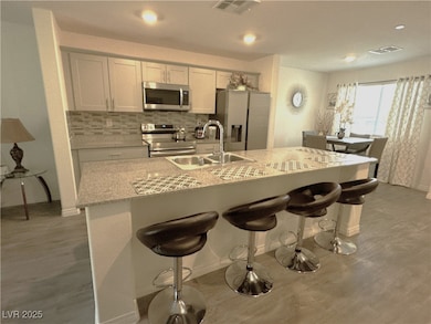 Kitchen with a sink, stainless steel appliances, v
