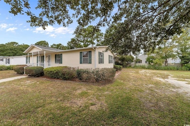 View of front facade featuring a porch and a front yard