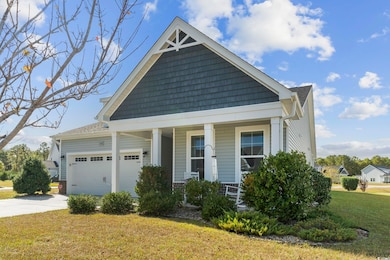 Craftsman inspired home with a front lawn, a garag