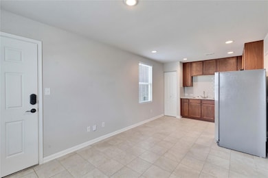 Kitchen featuring freestanding refrigerator, ligh