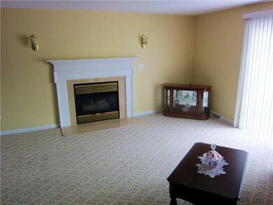 Living Room Gas Fireplace and Door Leading to Cove