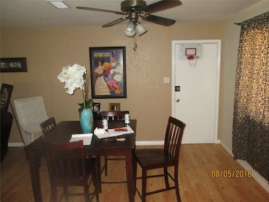 Dining area with wood finished floors and ceiling fan