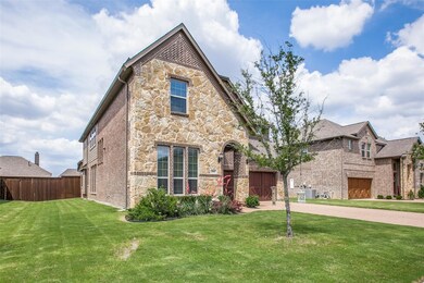 Tudor-style house with a front lawn and a garage